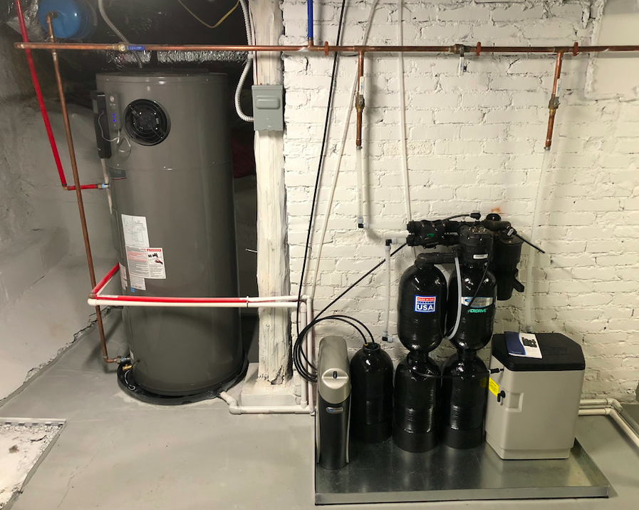 Heat pump water heater connected to a whole-home water purifier
