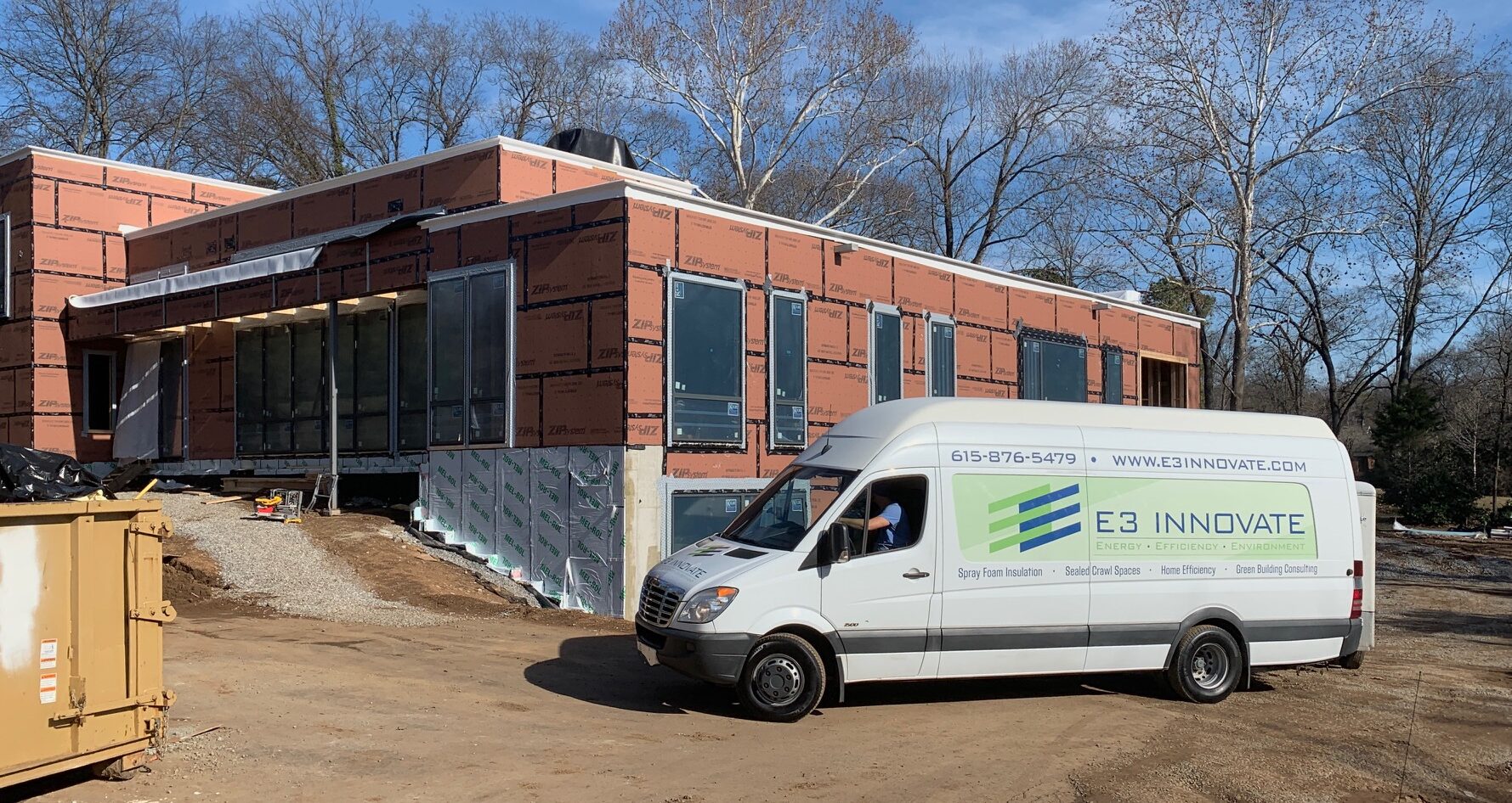 e3 innovate van in front of a new construction building