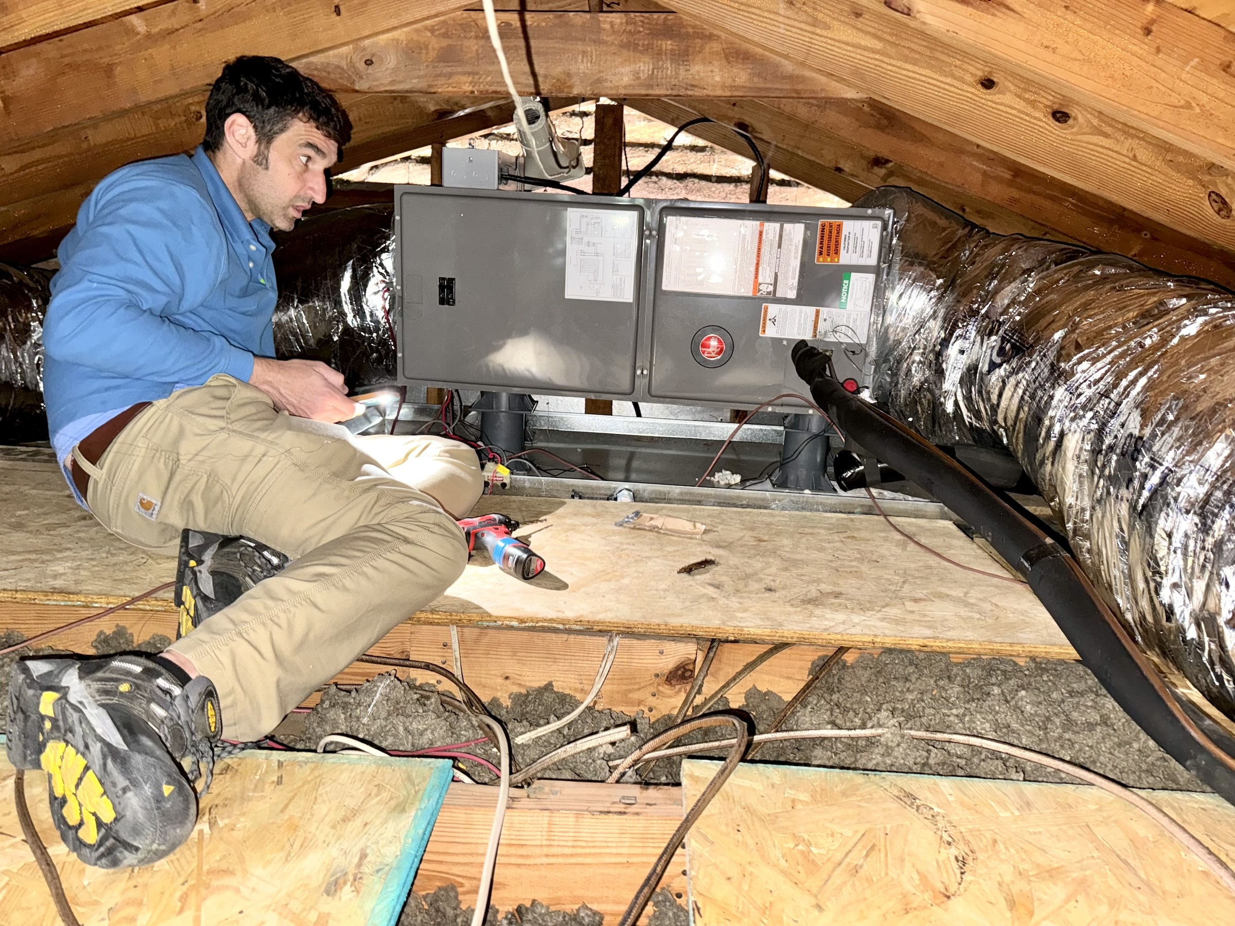 Member of E3 Innovate team performing home testing static pressure in attic