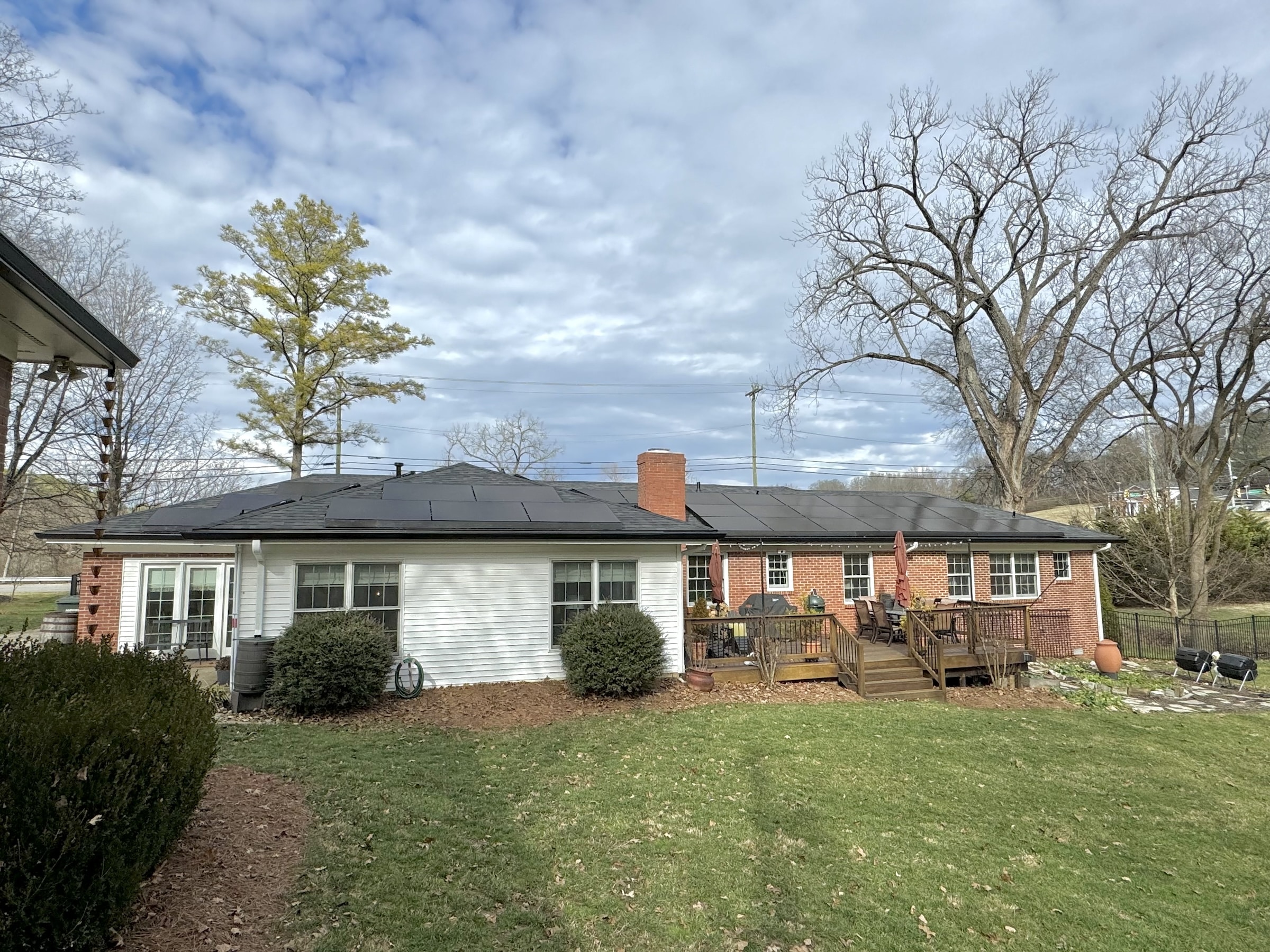Backyard of a house with solar panels on the roof